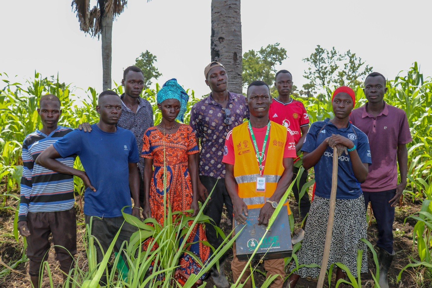 Abdul, Mwamba Kassim (in Reflector Jacket) and group members after field work in their 8-acre maize garden. Photo Credit: Wairimu Veronicah - RICE West Nile